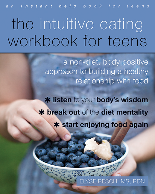 teen picking up a blueberry from a bowl