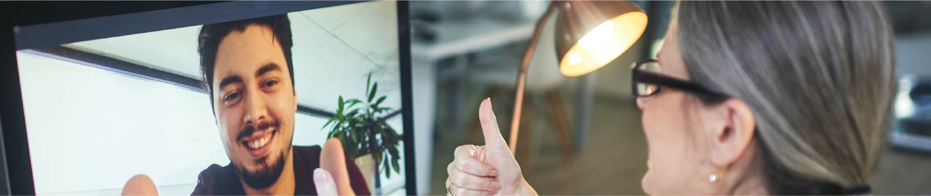 A therapist gives a thumbs-up to her online client
